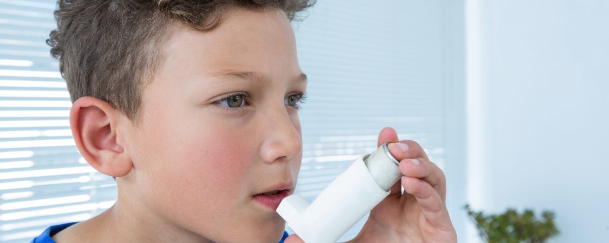 boy experience asthma attacks using asthma inhaler a clinic