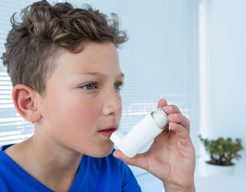 boy experience asthma attacks using asthma inhaler a clinic