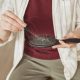 Woman have hair loss problems and holds a comb with hair falling out in her hand
