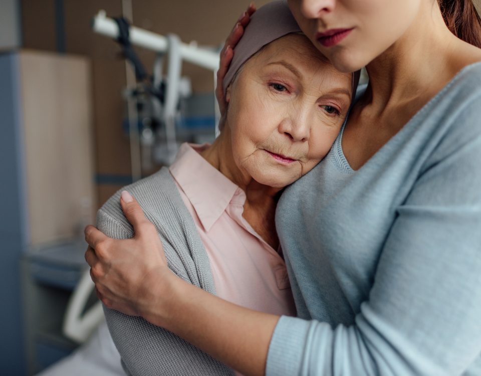 Daughter expresses her love for her mom who is fighting cancer by hugging her in the hospital